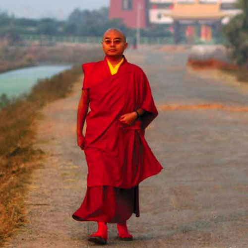 Mingyur Rinpoche walking away from Tergar Monastery in India