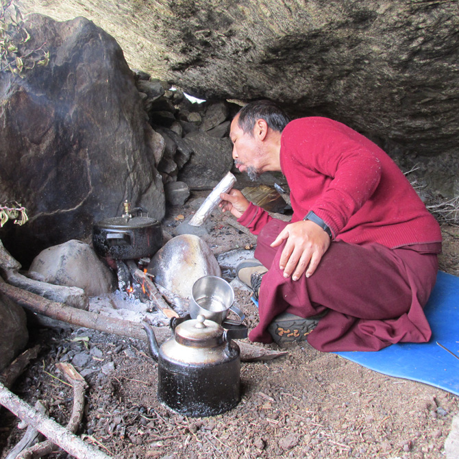 Lama Tashi cooking in a retreat cave. January 2014. Photo Mingyur Rinpoche?
